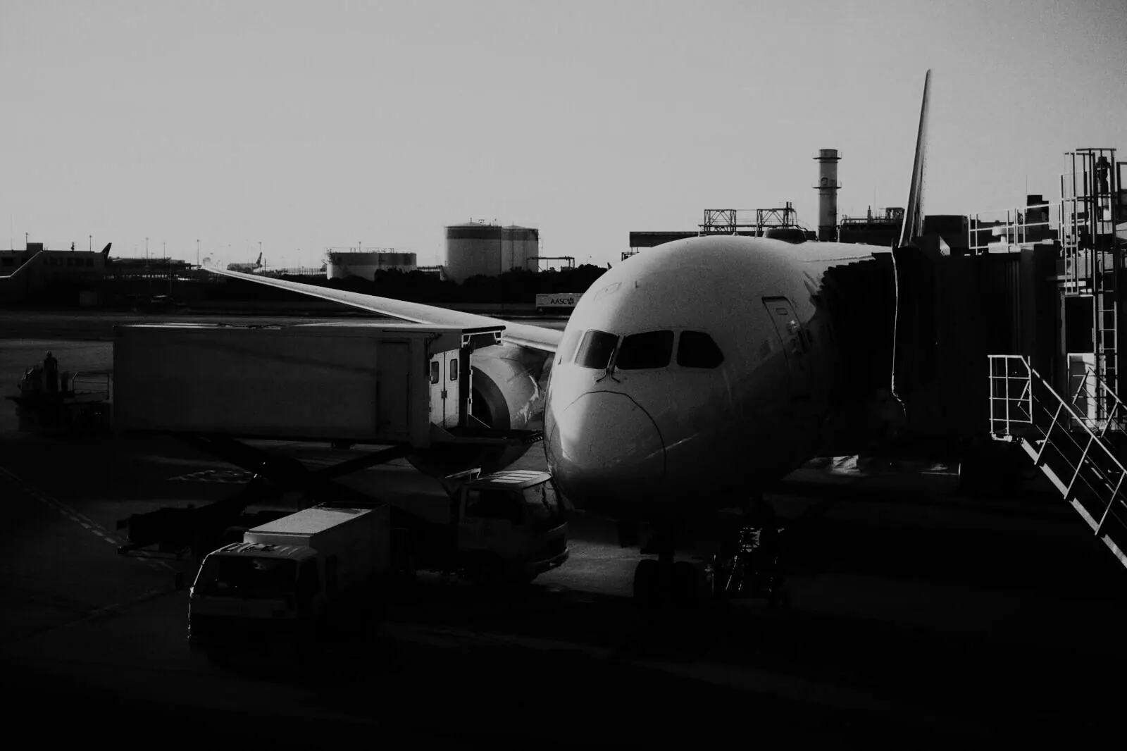 A catering hi-loader raised to an aircraft door at dawn.
